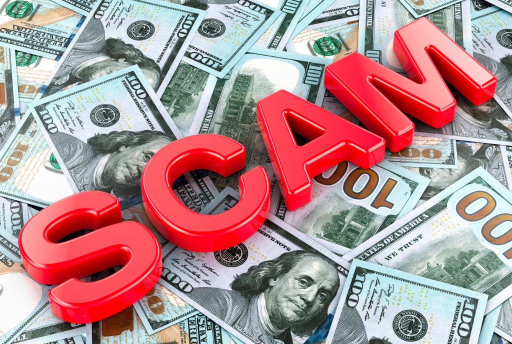 the word scam on top of money