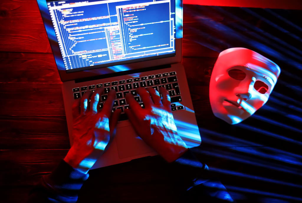 hacker with mask on table