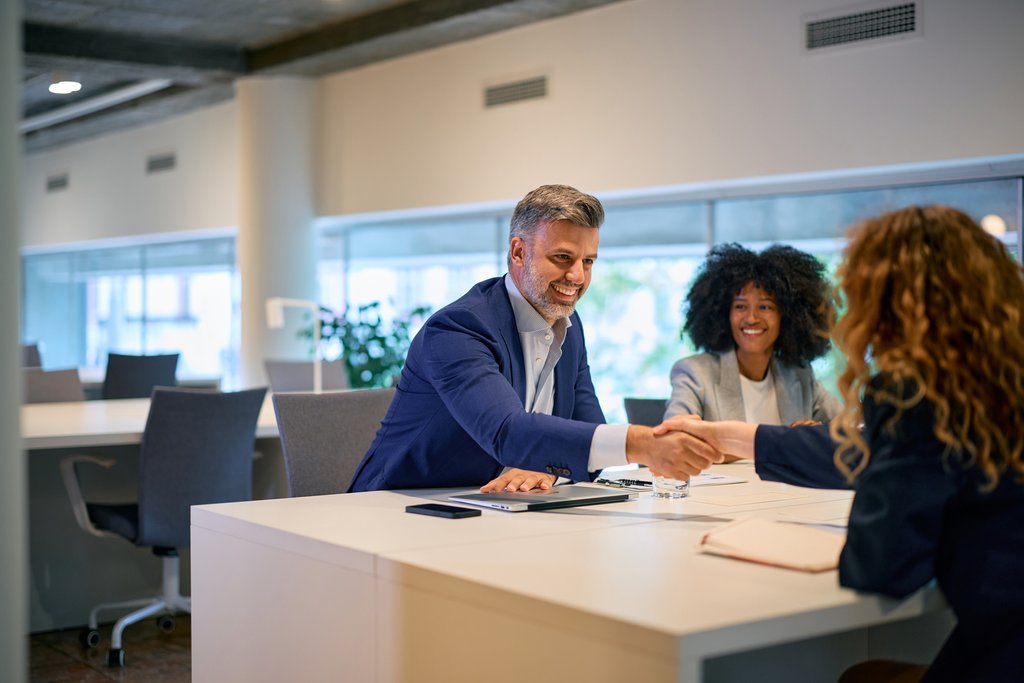 Man shaking hands with woman