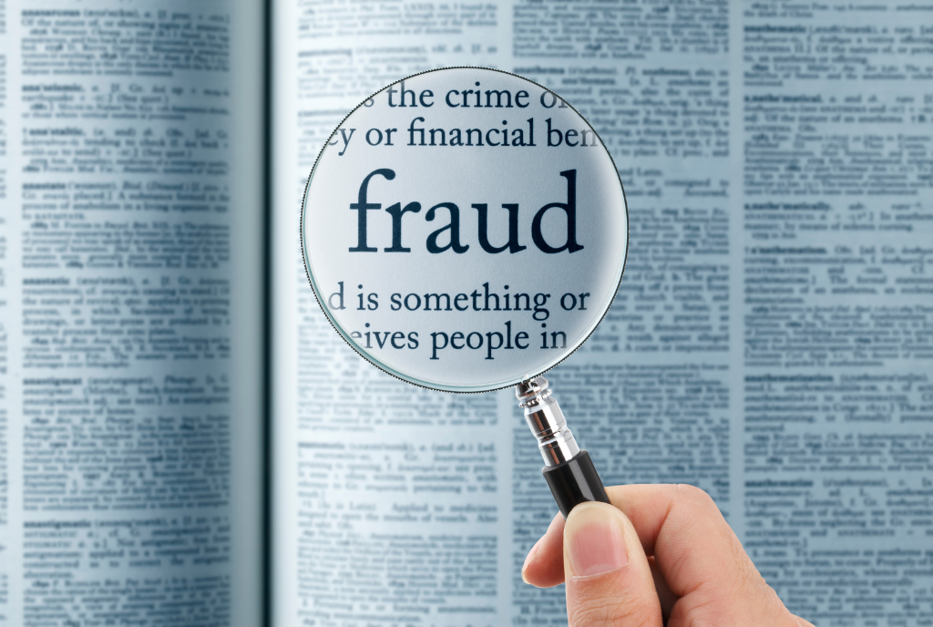 magnifying glass over the word fraud
