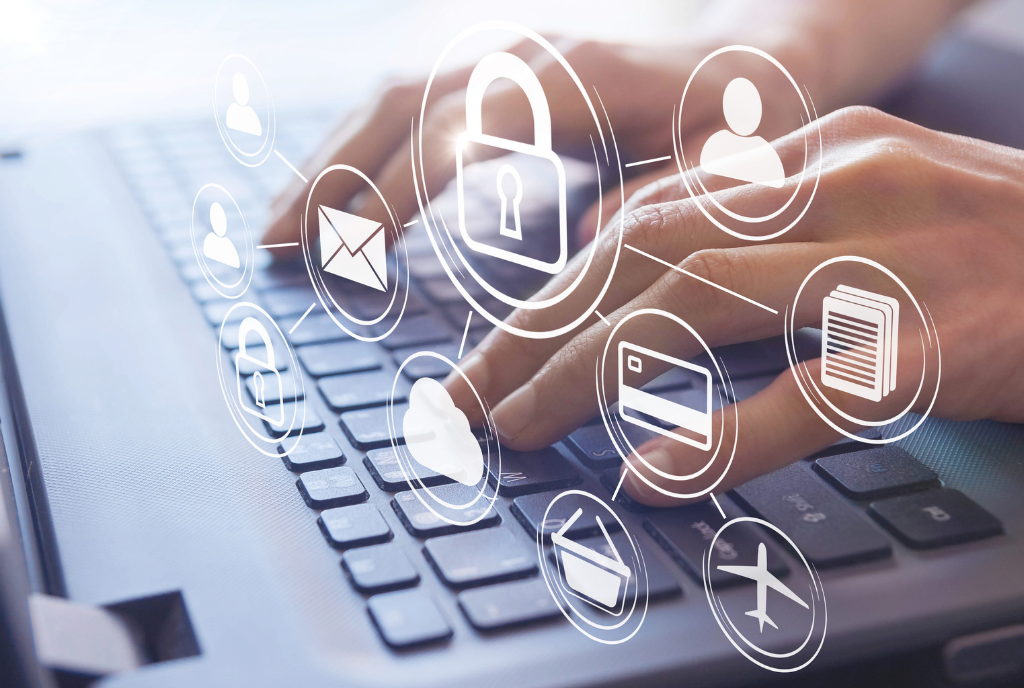 Hands typing on laptop keyboard with icons
