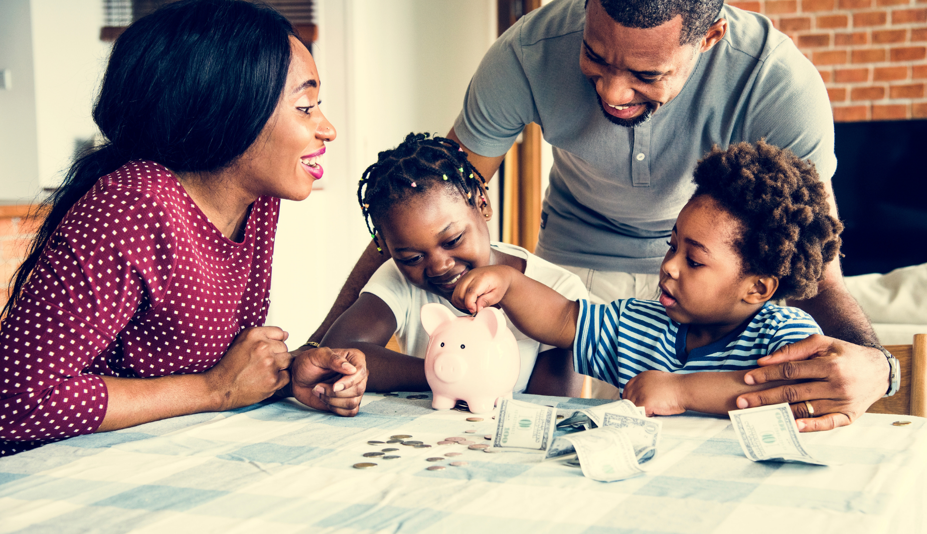 Family putting money in piggy bank