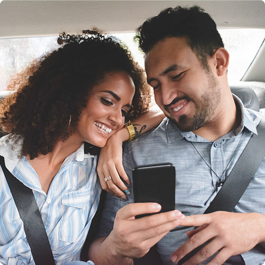 Couple viewing one of their phone