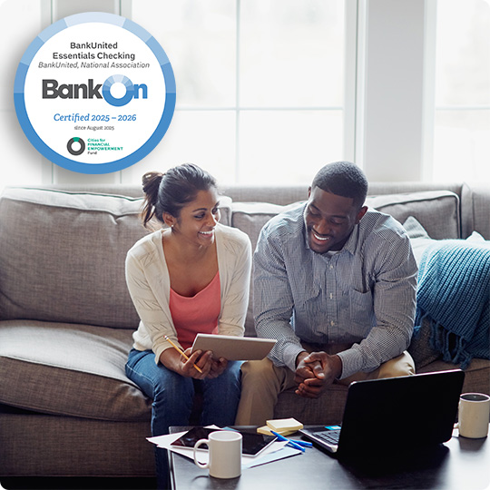 couple on couch looking at computer