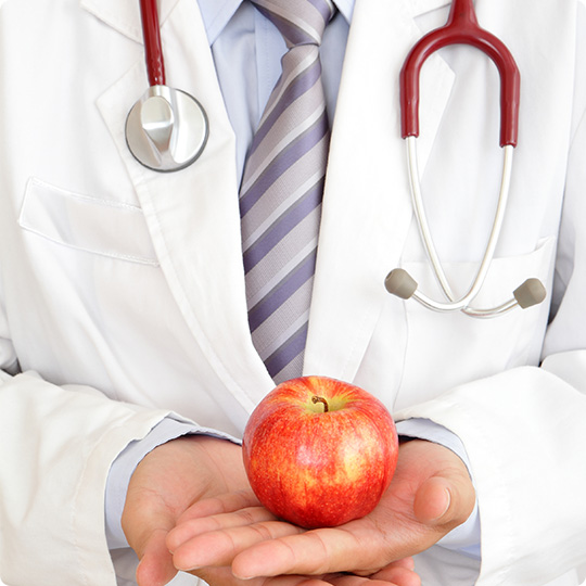 DOCTOR HOLDING AN APPLE