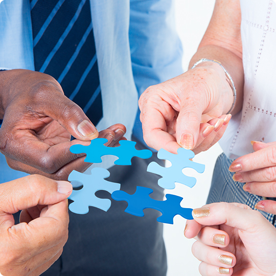 People holding pieces of a puzzle