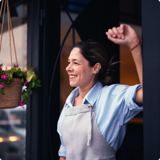 Woman standing in a doorway smiling
