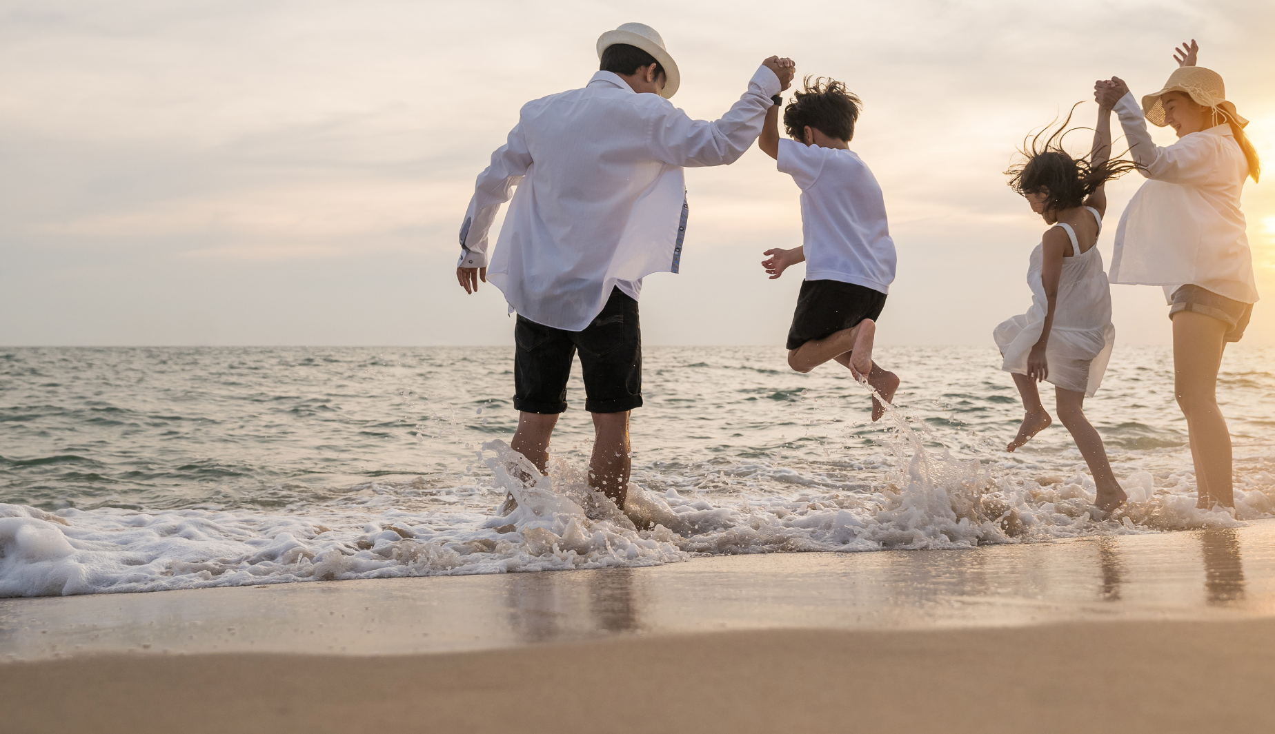family playing on beach