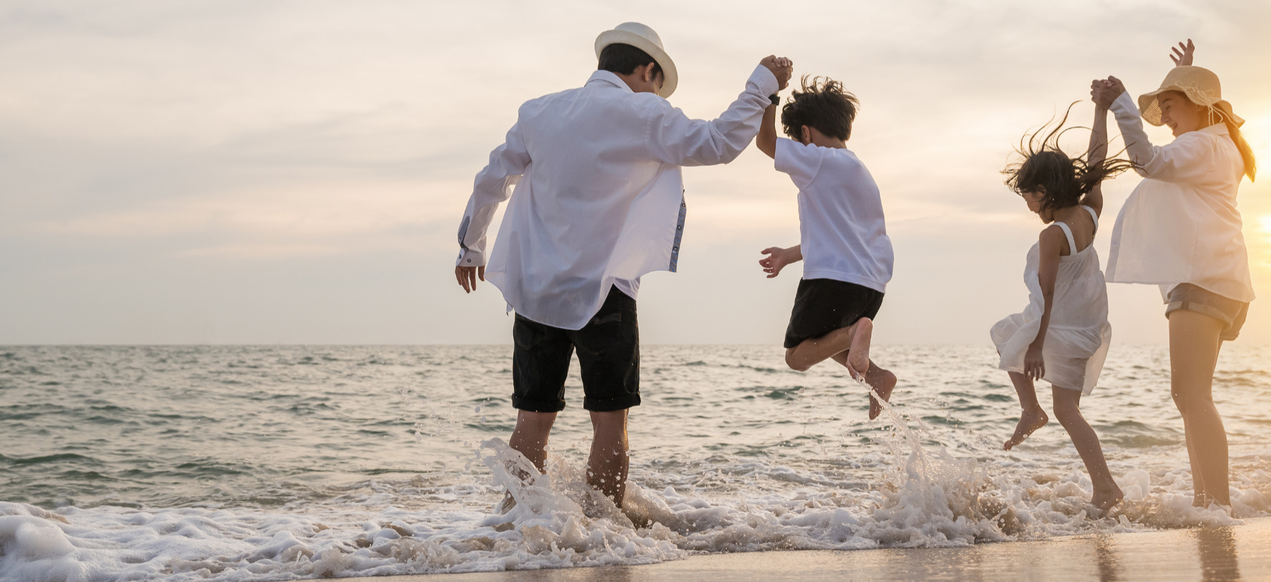 family playing on beach