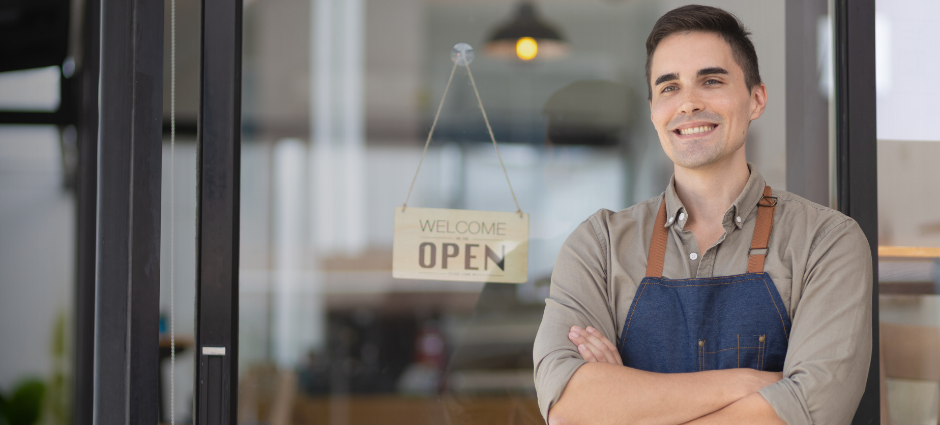 Business owner standing outside his shop