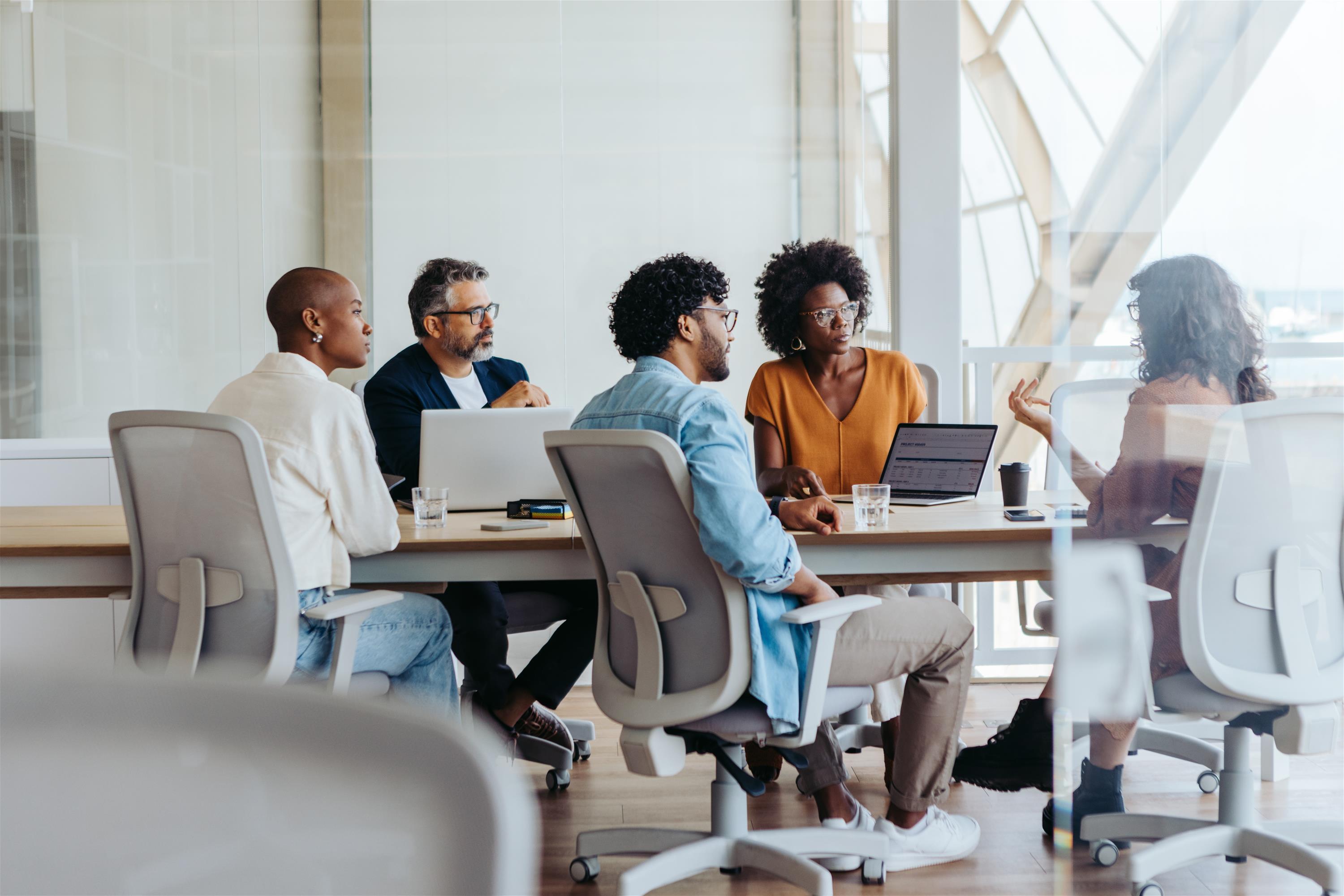 group of professionals brainstorming at a table in an office
