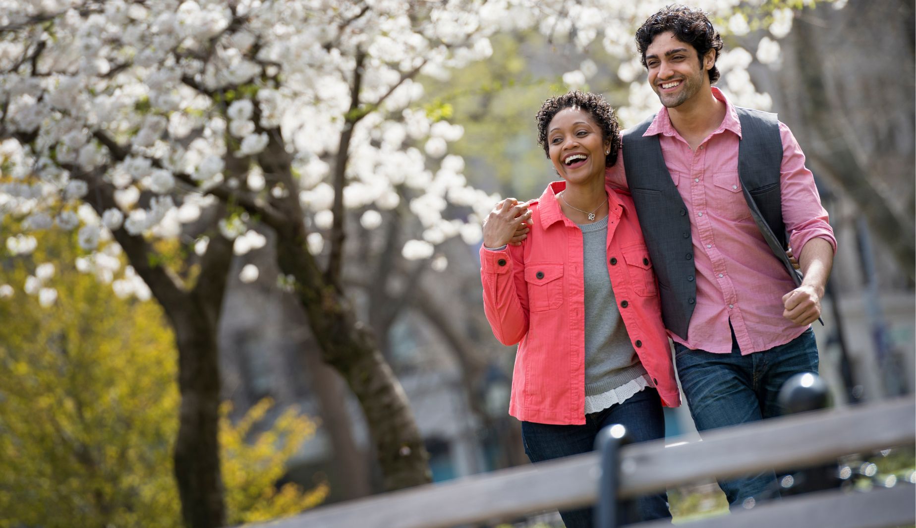 Couple walking through a park in Spring